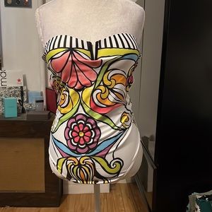 White strapless bathing suit w/brightly colored design and b&w stripes along top